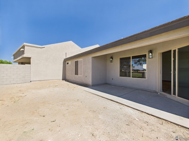12116 E Calle Del Cid Unit B, Yuma, AZ 85367 - back of property featuring a patio area and stucco siding
