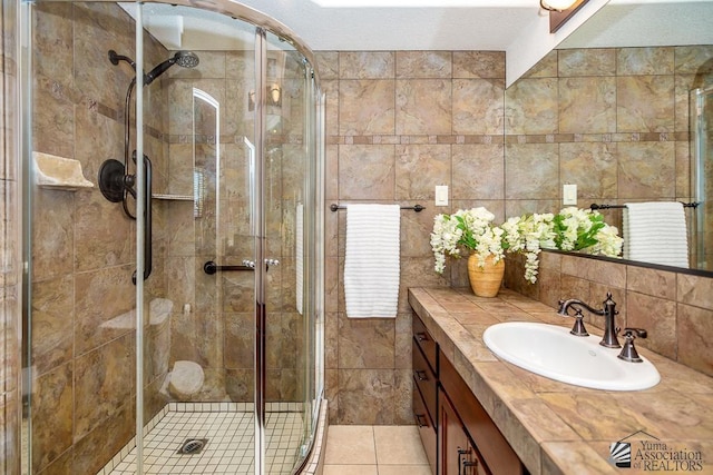 500 E Country Club Dr # 14, Yuma, AZ 85365 - bathroom featuring vanity, tile patterned flooring, a stall shower, and tile walls