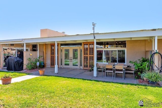 500 E Country Club Dr # 14, Yuma, AZ 85365 - rear view of house with french doors, a patio, stucco siding, and a yard
