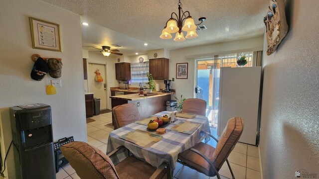 4671 W 21st Ln, Yuma, AZ 85364 - dining space featuring light tile patterned floors, a textured ceiling, a chandelier, a textured wall, and ceiling fan
