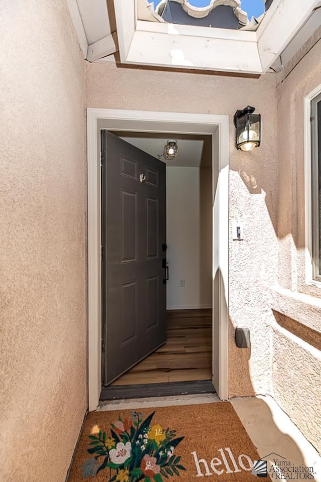 property entrance with stucco siding