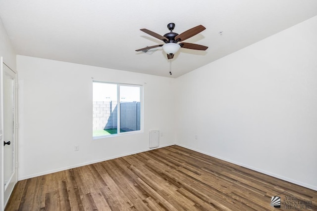 empty room with baseboards, ceiling fan, and wood finished floors