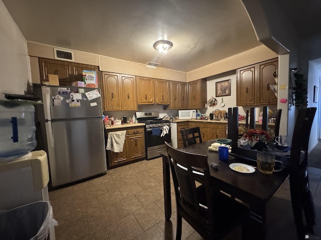 kitchen with stainless steel appliances, light countertops, and visible vents