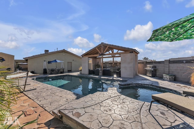 11812 E Eclipse Ct, Yuma, AZ 85367 - view of pool with area for grilling, a pool with connected hot tub, a patio area, a gazebo, and a fenced backyard