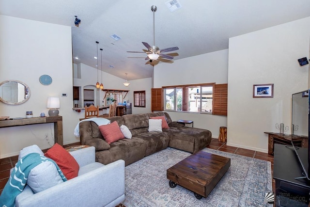 tiled living area with baseboards, ceiling fan, high vaulted ceiling, and visible vents