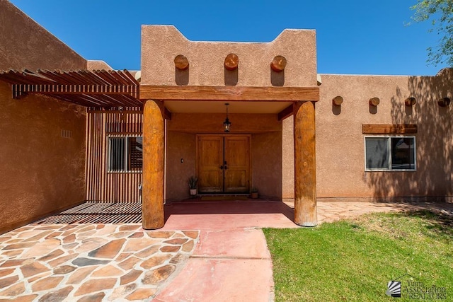 entrance to property featuring a pergola