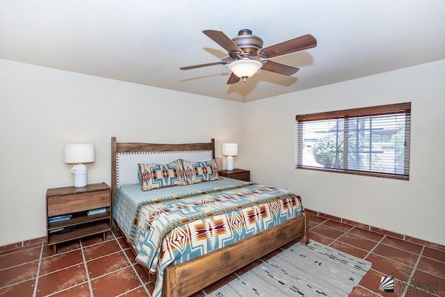 bedroom featuring tile patterned flooring, baseboards, and ceiling fan