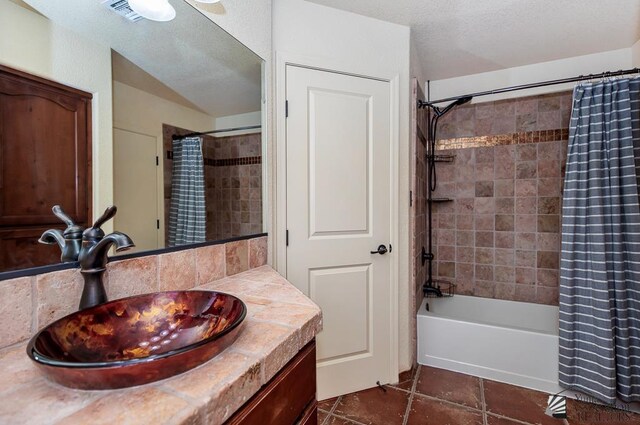 bathroom with visible vents, tile patterned floors, shower / tub combo, and vanity