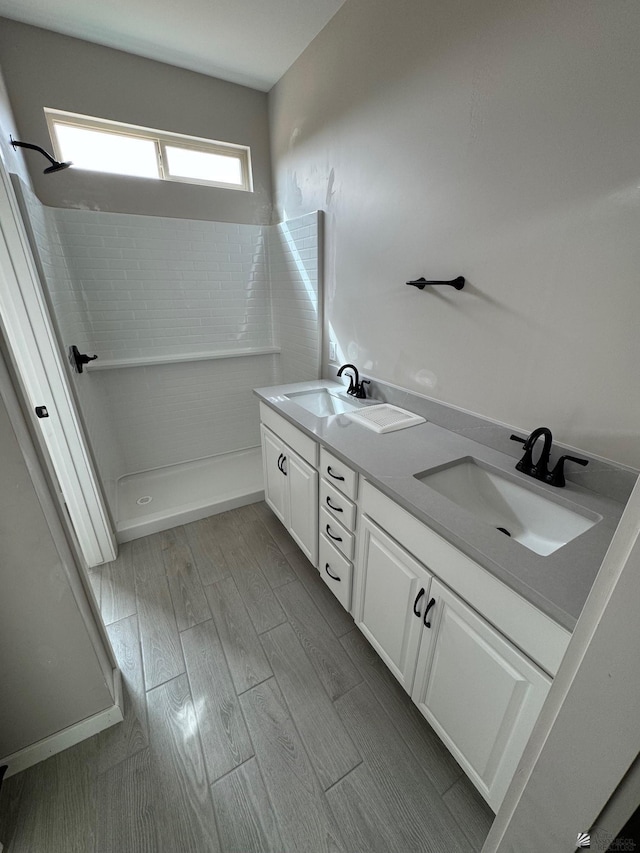 7701 E 35th Pl, Yuma, AZ 85365 - bathroom with double vanity, a sink, walk in shower, and wood finished floors