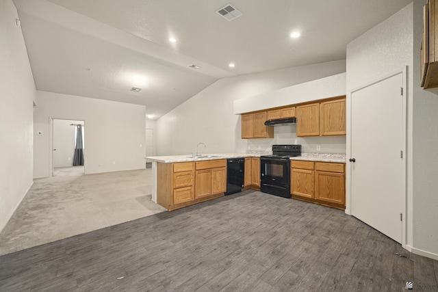 kitchen with sink, vaulted ceiling, kitchen peninsula, hardwood / wood-style flooring, and black appliances