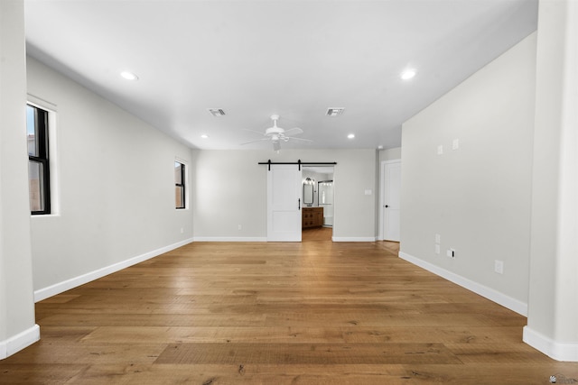 10369 S Fairway Loop, Yuma, AZ 85367 - unfurnished living room featuring recessed lighting, a ceiling fan, light wood finished floors, and a barn door
