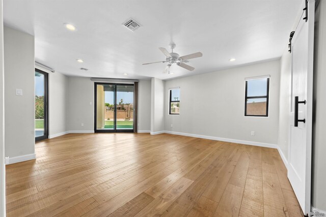 10369 S Fairway Loop, Yuma, AZ 85367 - empty room featuring a barn door, plenty of natural light, recessed lighting, ceiling fan, and light wood-style floors