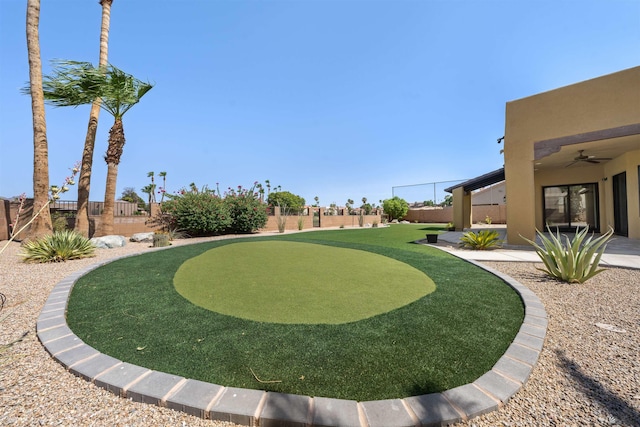 10369 S Fairway Loop, Yuma, AZ 85367 - fenced backyard with a ceiling fan and a putting area