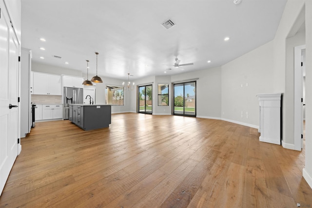 10369 S Fairway Loop, Yuma, AZ 85367 - unfurnished living room with a chandelier, light wood-type flooring, ceiling fan, and recessed lighting