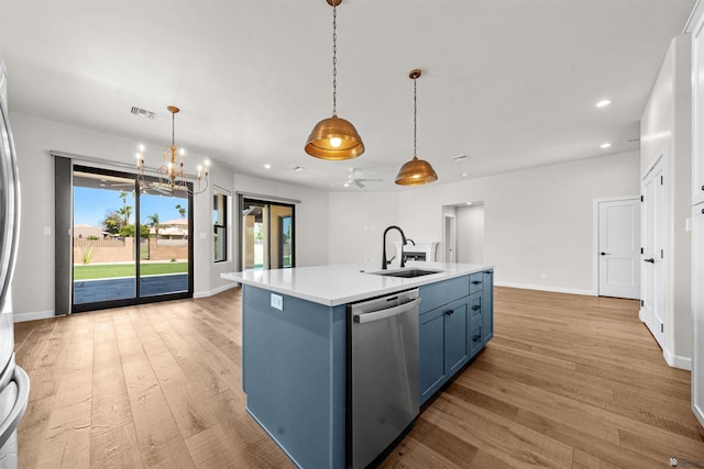 10369 S Fairway Loop, Yuma, AZ 85367 - kitchen with stainless steel dishwasher, blue cabinetry, light wood-style floors, light countertops, and a chandelier