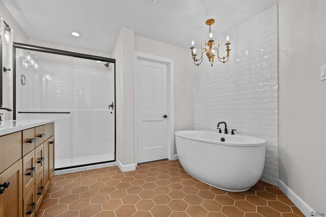 10369 S Fairway Loop, Yuma, AZ 85367 - full bath with a soaking tub, a shower stall, vanity, tile patterned flooring, and a chandelier