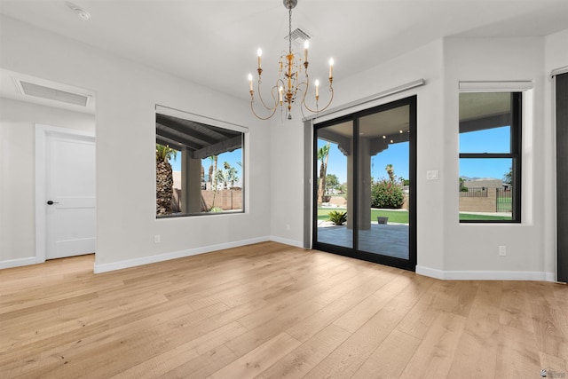 10369 S Fairway Loop, Yuma, AZ 85367 - empty room featuring a chandelier, light wood-type flooring, and a smoke detector
