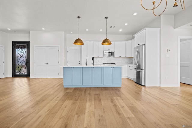10369 S Fairway Loop, Yuma, AZ 85367 - kitchen with stainless steel appliances, light countertops, white cabinets, recessed lighting, and light wood-style flooring
