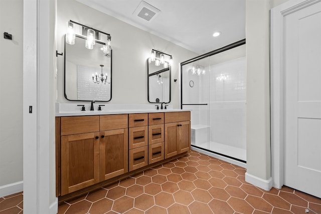 10369 S Fairway Loop, Yuma, AZ 85367 - bathroom with a stall shower, double vanity, a chandelier, tile patterned floors, and recessed lighting