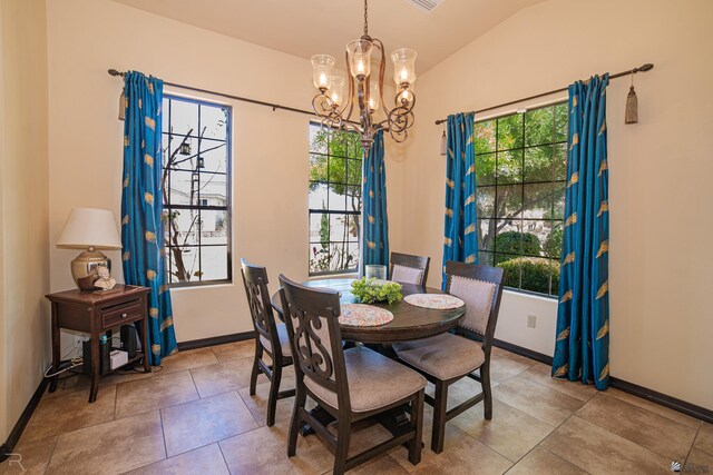 15732 S Via Cortile Way, Yuma, AZ 85365 - dining room featuring a chandelier, vaulted ceiling, baseboards, and tile patterned flooring