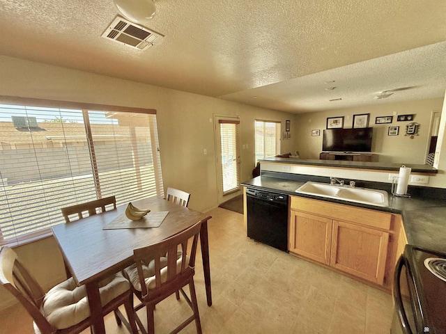 6347 E 44th Pl, Yuma, AZ 85365 - kitchen with black appliances, a textured ceiling, dark countertops, a peninsula, and open floor plan