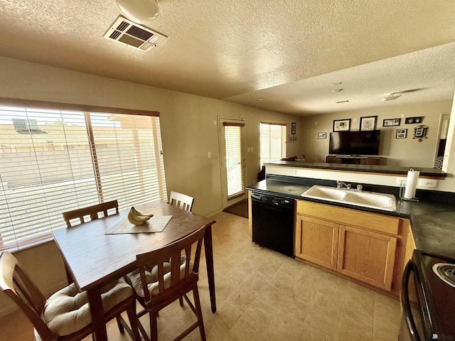 6347 E 44th Pl, Yuma, AZ 85365 - kitchen featuring black appliances, a textured ceiling, dark countertops, a peninsula, and brown cabinetry