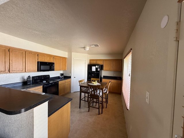 6347 E 44th Pl, Yuma, AZ 85365 - kitchen featuring black appliances, dark countertops, light flooring, a peninsula, and a textured ceiling