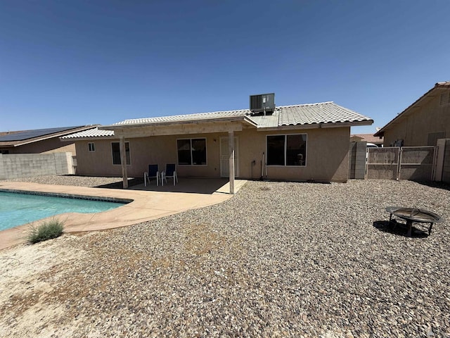 6347 E 44th Pl, Yuma, AZ 85365 - rear view of property with a fenced backyard, an outdoor fire pit, stucco siding, and a patio