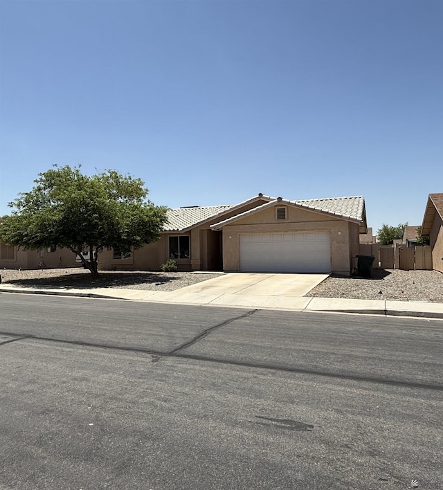 6347 E 44th Pl, Yuma, AZ 85365 - view of front of property with an attached garage, concrete driveway, a tile roof, and stucco siding
