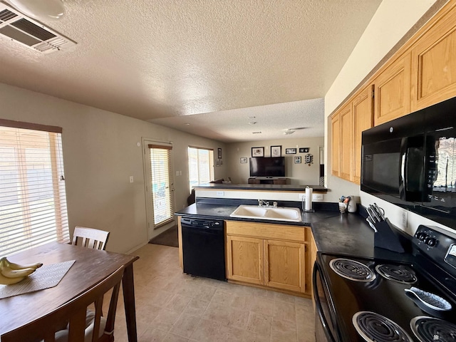 6347 E 44th Pl, Yuma, AZ 85365 - kitchen featuring black appliances, a peninsula, dark countertops, a textured ceiling, and open floor plan