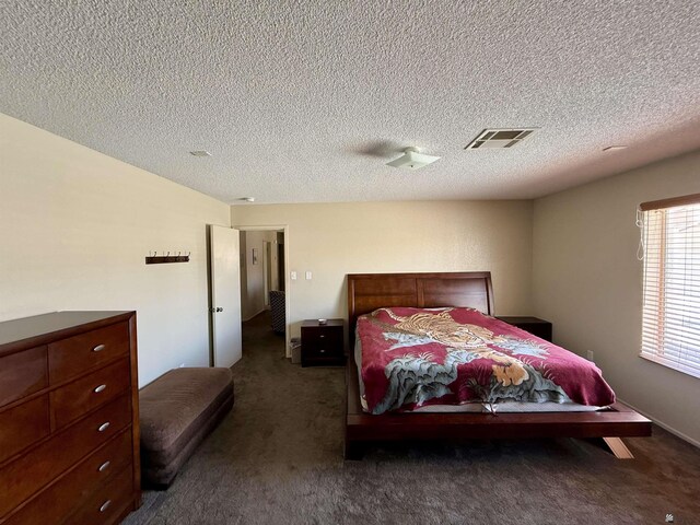 6347 E 44th Pl, Yuma, AZ 85365 - bedroom featuring dark carpet and a textured ceiling