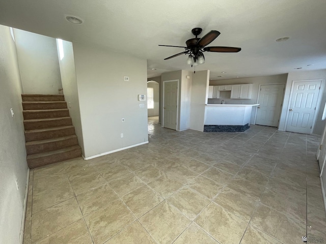 unfurnished living room with ceiling fan