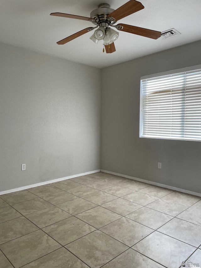 empty room featuring ceiling fan and light tile patterned floors