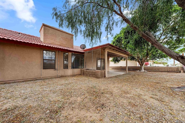 10266 S Del Rico, Yuma, AZ 85367 - back of property featuring fence, a tile roof, stucco siding, a chimney, and a patio