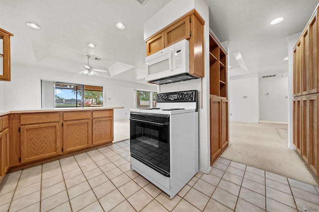 10266 S Del Rico, Yuma, AZ 85367 - kitchen with light tile patterned flooring, light carpet, ceiling fan, white microwave, and electric stove