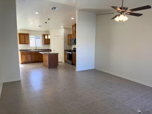 3751 E Santa Palmira St, San Luis, AZ 85336 - unfurnished living room featuring dark tile patterned flooring, ceiling fan, visible vents, and baseboards