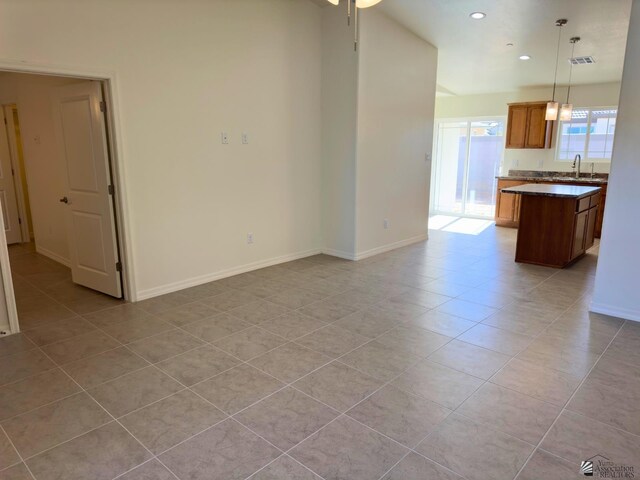 3751 E Santa Palmira St, San Luis, AZ 85336 - unfurnished living room with a sink, recessed lighting, baseboards, light tile patterned floors, and visible vents