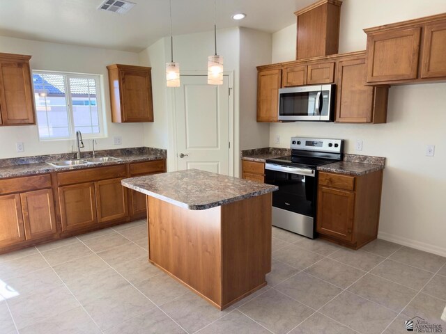 3751 E Santa Palmira St, San Luis, AZ 85336 - kitchen with brown cabinetry, a sink, and appliances with stainless steel finishes