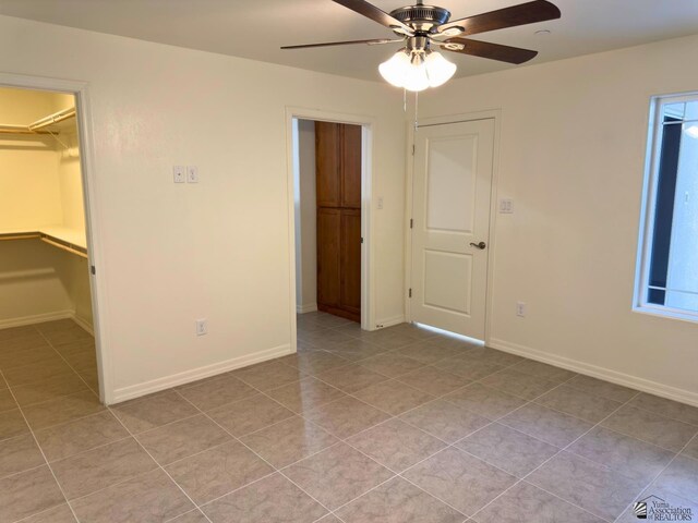 3751 E Santa Palmira St, San Luis, AZ 85336 - unfurnished bedroom featuring a closet, light tile patterned flooring, baseboards, a walk in closet, and ceiling fan