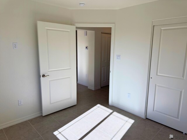 3751 E Santa Palmira St, San Luis, AZ 85336 - unfurnished bedroom with tile patterned floors, baseboards, and a closet