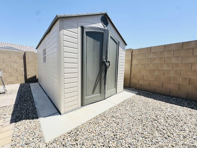 view of shed with a fenced backyard