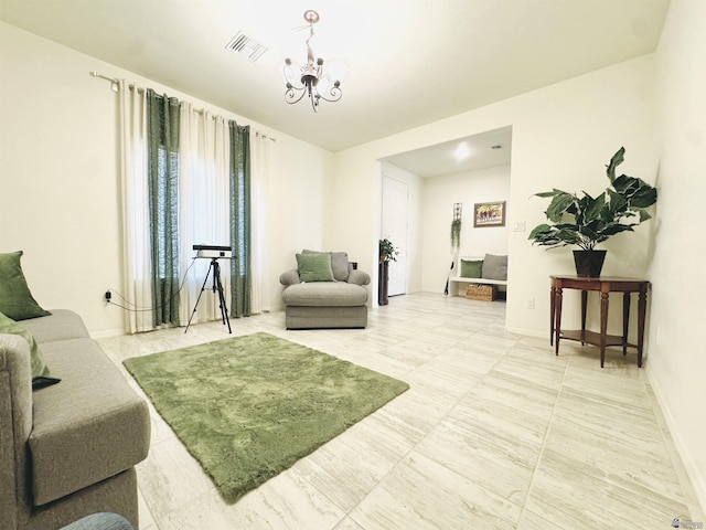 living room with visible vents, baseboards, and a chandelier