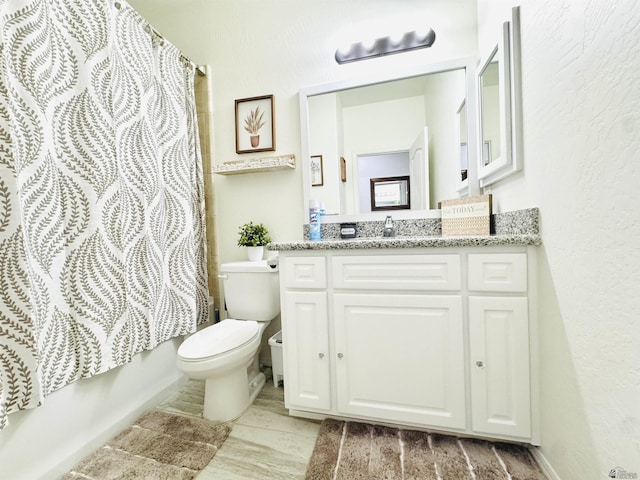 bathroom featuring vanity, toilet, and shower / tub combo