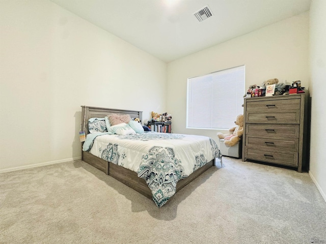 bedroom with baseboards, light carpet, and visible vents