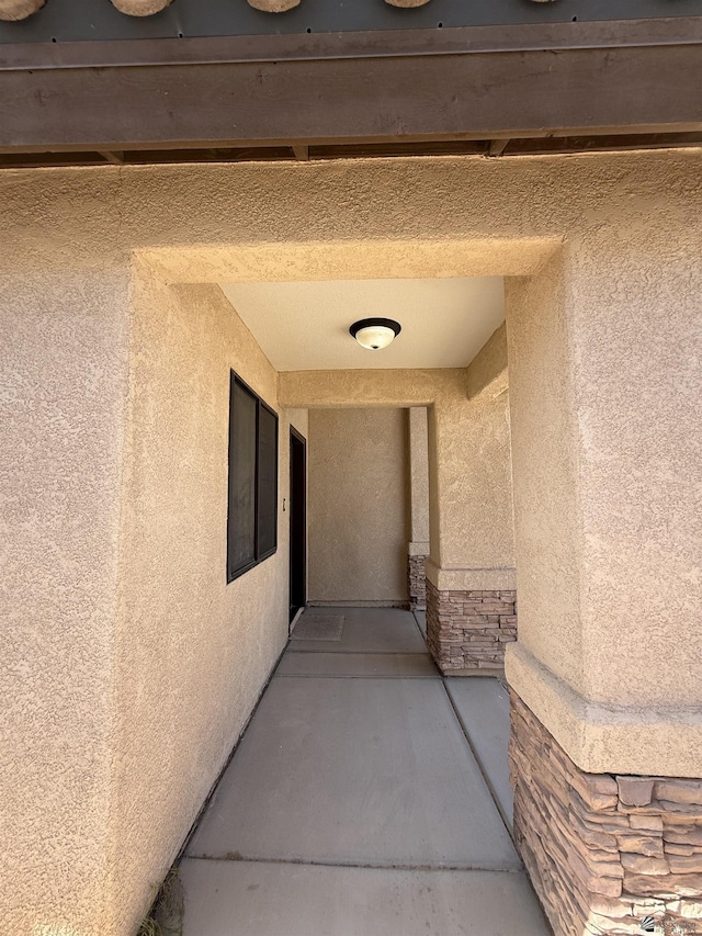 126 N Joe Harper Ct, San Luis, AZ 85349 - doorway to property with stucco siding and stone siding