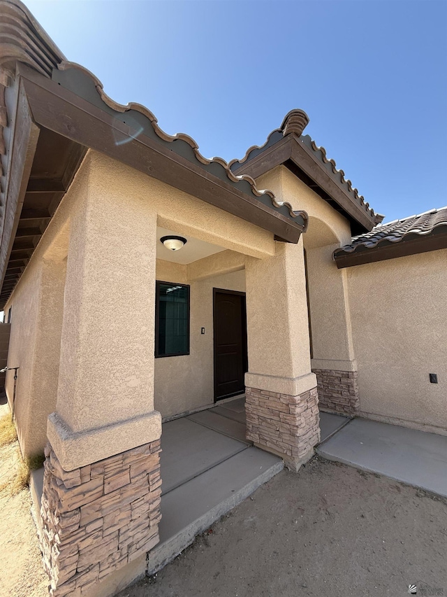 126 N Joe Harper Ct, San Luis, AZ 85349 - property entrance with stucco siding and stone siding