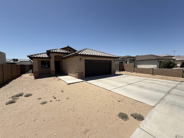 126 N Joe Harper Ct, San Luis, AZ 85349 - mediterranean / spanish house featuring a garage, stucco siding, driveway, and a tile roof