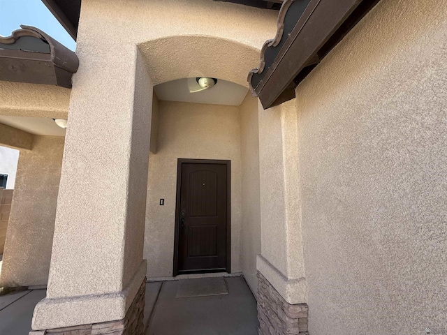 126 N Joe Harper Ct, San Luis, AZ 85349 - doorway to property featuring stucco siding and stone siding