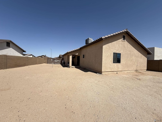 126 N Joe Harper Ct, San Luis, AZ 85349 - rear view of property featuring stucco siding, a tile roof, and a fenced backyard