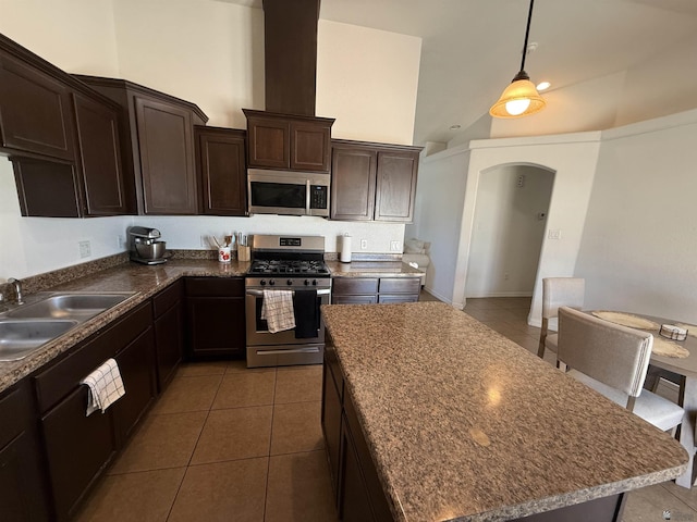 126 N Joe Harper Ct, San Luis, AZ 85349 - kitchen featuring appliances with stainless steel finishes, a sink, tile patterned floors, dark brown cabinets, and arched walkways